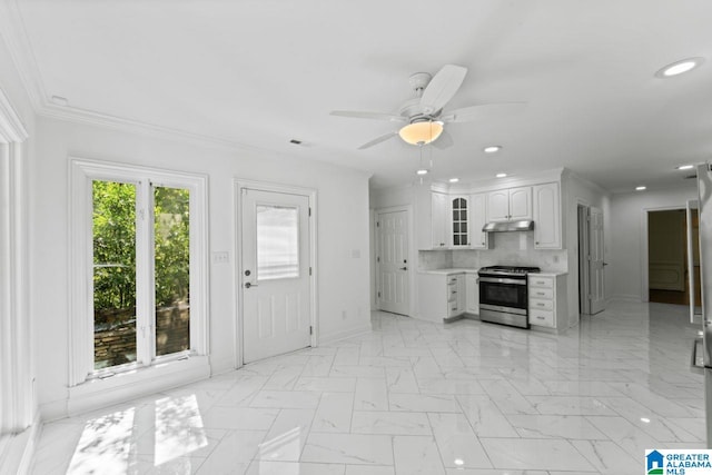 kitchen with white cabinets, decorative backsplash, crown molding, ceiling fan, and stainless steel range with gas cooktop