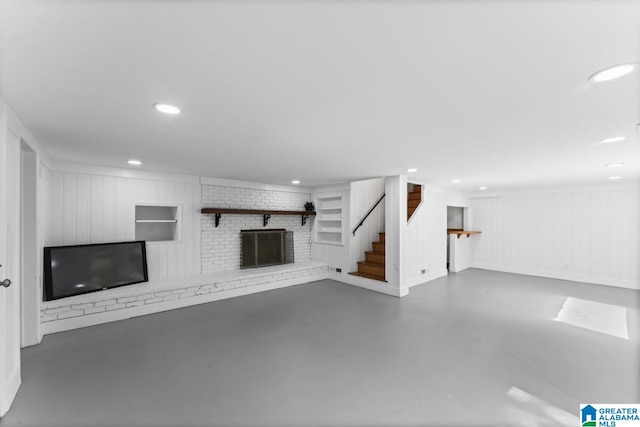 unfurnished living room featuring a brick fireplace