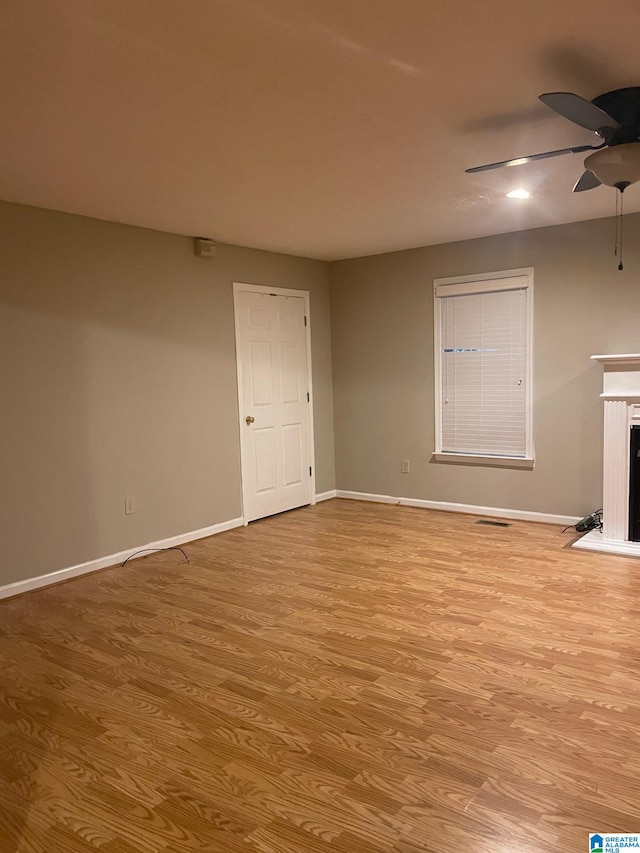 unfurnished living room featuring light hardwood / wood-style flooring and ceiling fan