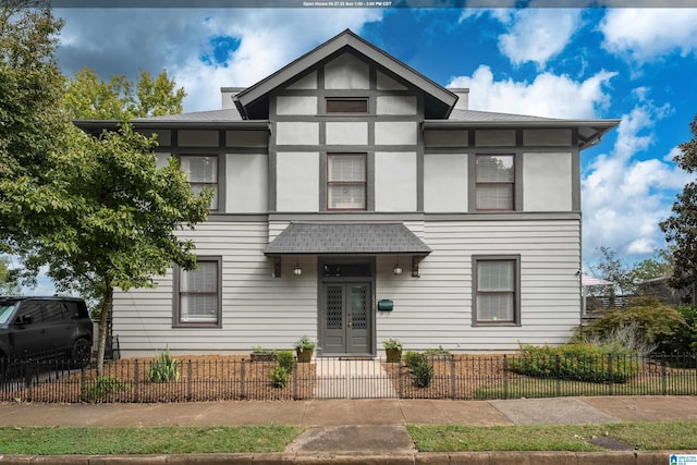 view of front of home with a fenced front yard and stucco siding