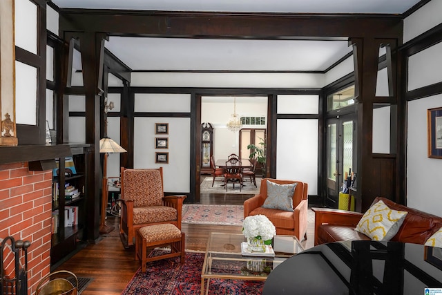 living room with crown molding, a notable chandelier, and hardwood / wood-style floors