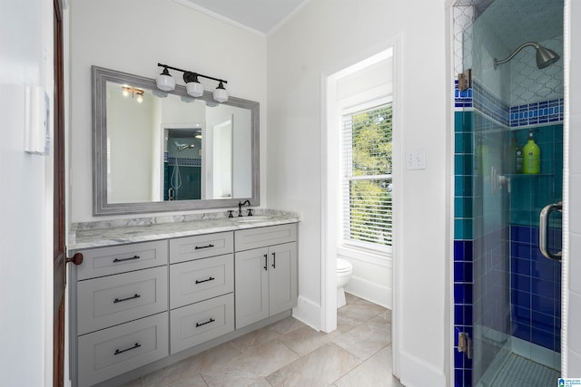 bathroom featuring a shower with door, vanity, toilet, ornamental molding, and tile patterned floors