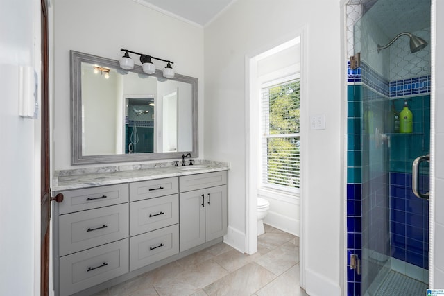 bathroom with tile patterned floors, toilet, a stall shower, vanity, and ornamental molding