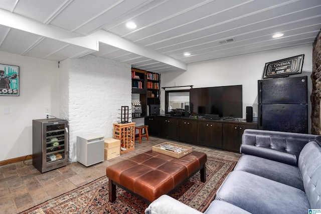 living room with recessed lighting, wine cooler, visible vents, stone finish flooring, and baseboards