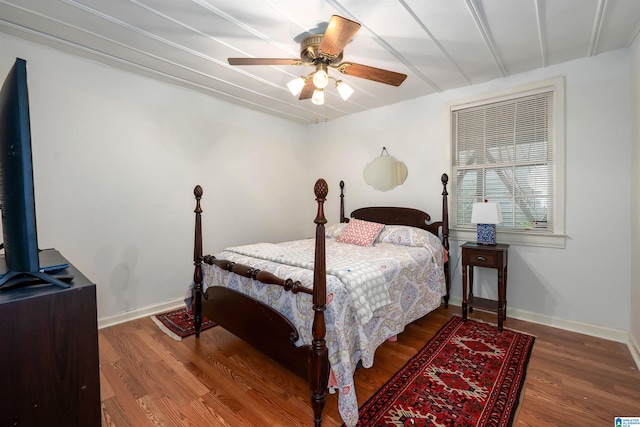 bedroom with baseboards, a ceiling fan, and wood finished floors