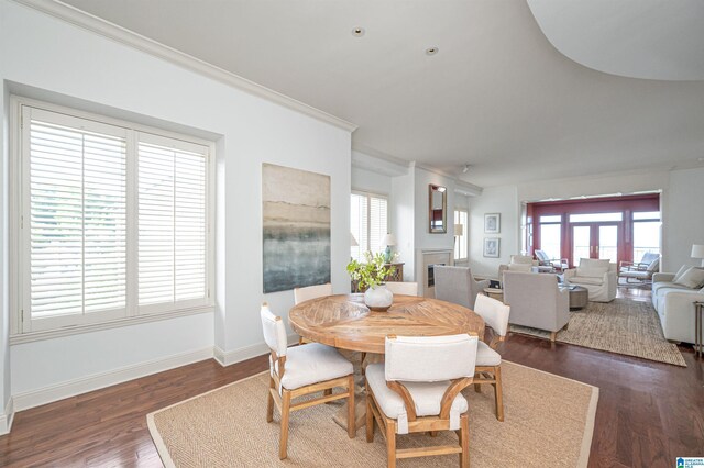 dining room featuring dark hardwood / wood-style flooring and crown molding