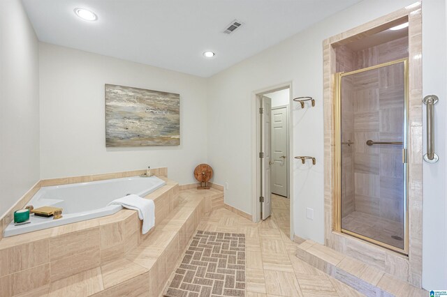 bathroom with tile patterned floors and shower with separate bathtub