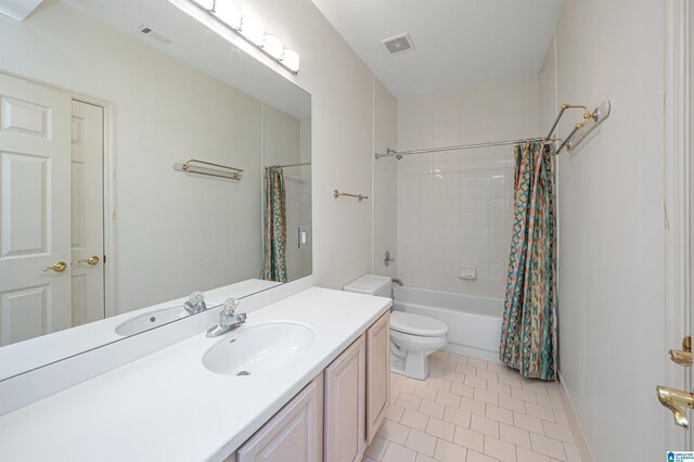 full bathroom featuring tile patterned floors, shower / bath combo, toilet, and vanity