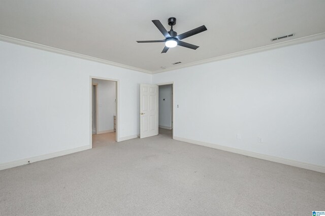 unfurnished bedroom featuring ceiling fan, light colored carpet, and ornamental molding