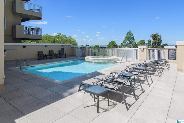 view of pool with a community hot tub and a patio