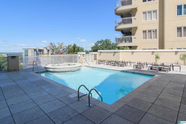 view of pool featuring a hot tub and a patio area