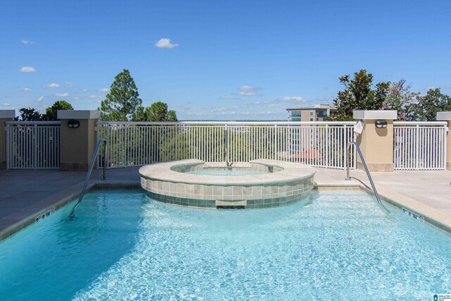 view of pool with a community hot tub