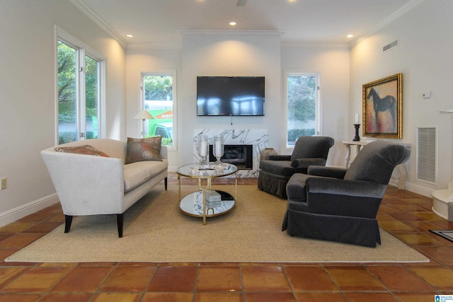 living room featuring crown molding, dark tile patterned floors, and a fireplace