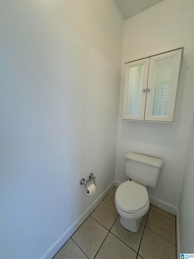 bathroom with tile patterned floors and toilet