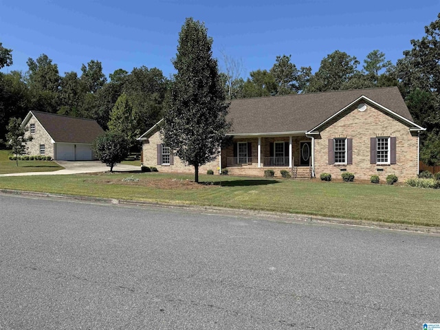 single story home featuring brick siding, a porch, a front lawn, and a garage