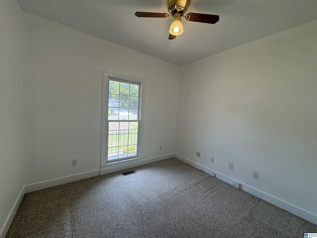 spare room featuring carpet, visible vents, a ceiling fan, and baseboards