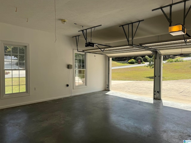 garage with a garage door opener and a yard