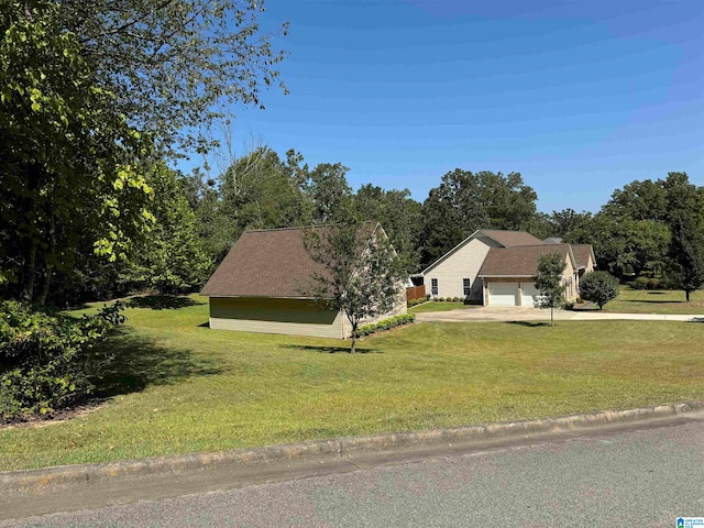 view of front of home featuring a garage and a front lawn