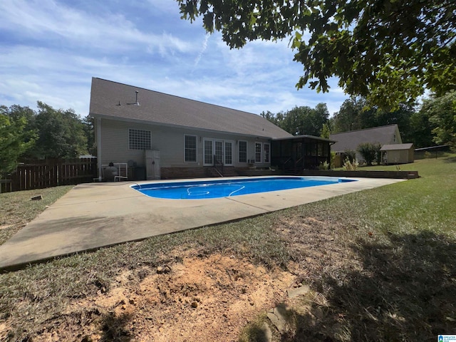 view of swimming pool featuring a patio area and a yard