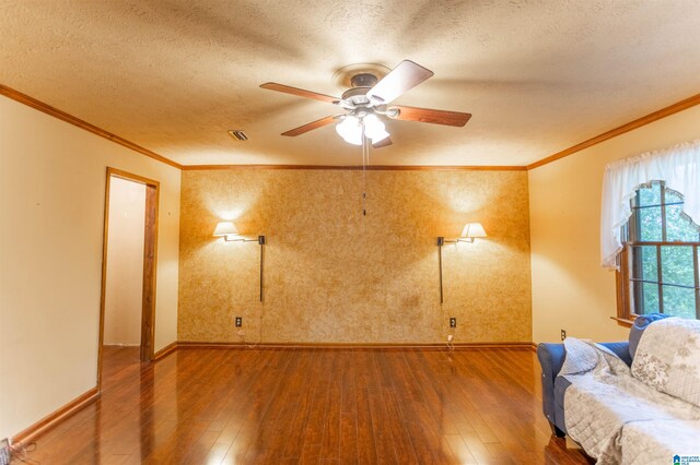 living room with ornamental molding, hardwood / wood-style flooring, and ceiling fan