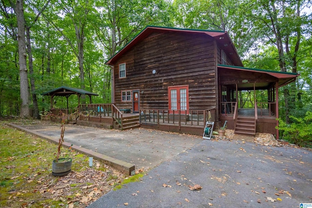 exterior space with a wooden deck and a gazebo