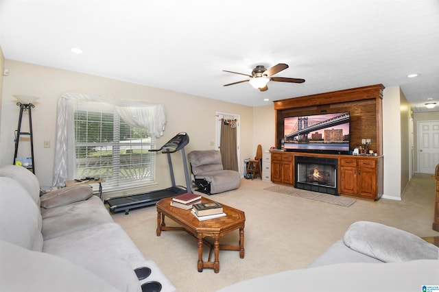 carpeted living room featuring ceiling fan