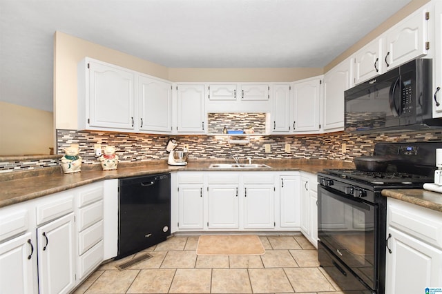 kitchen featuring black appliances, sink, light tile patterned flooring, and white cabinets