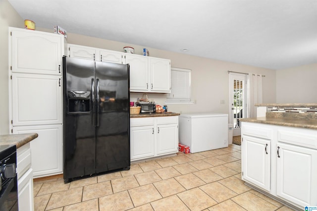 kitchen with fridge with ice dispenser, fridge, and white cabinets