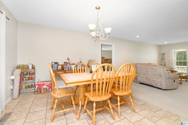 dining room featuring an inviting chandelier and light carpet