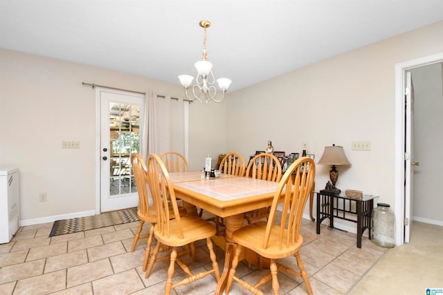 dining area with a notable chandelier and light tile patterned flooring