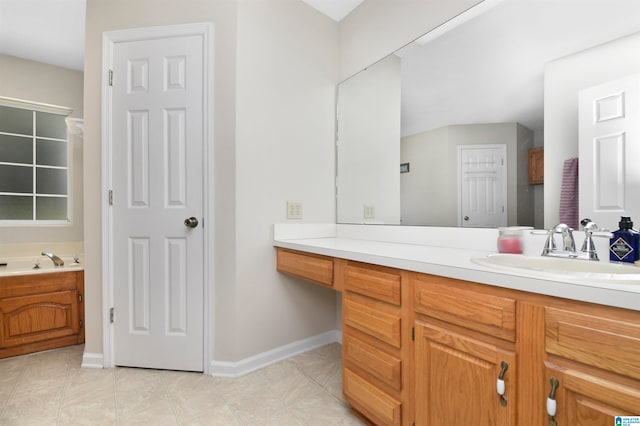 bathroom with tile patterned flooring, vanity, and a bathtub