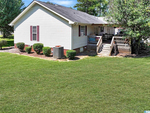 exterior space with a yard, central AC, and a wooden deck