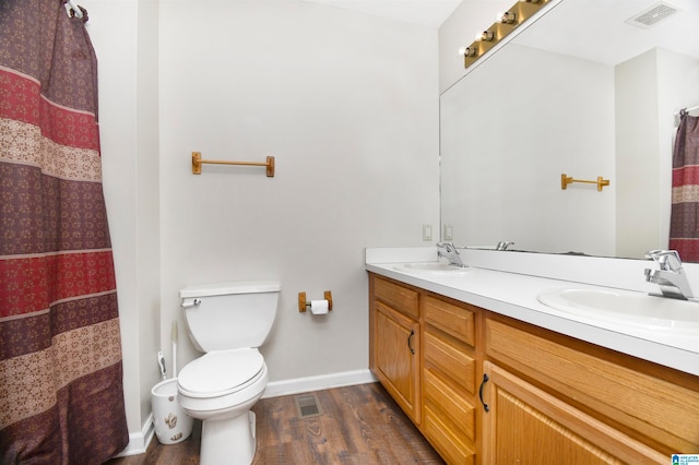 bathroom featuring vanity, toilet, wood-type flooring, and curtained shower