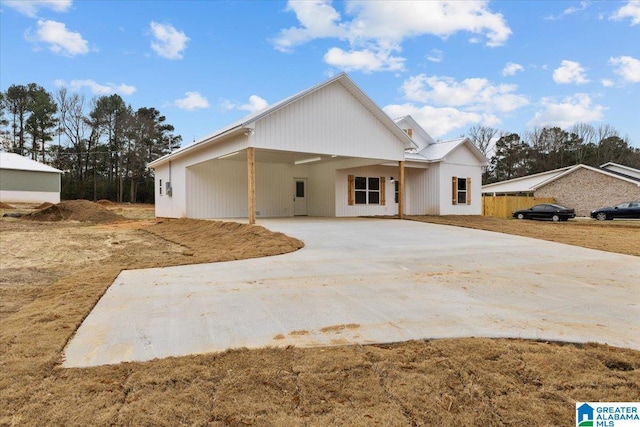 modern farmhouse style home featuring a carport