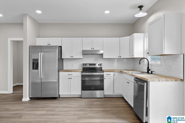 kitchen with sink, white cabinetry, stainless steel appliances, and light hardwood / wood-style flooring