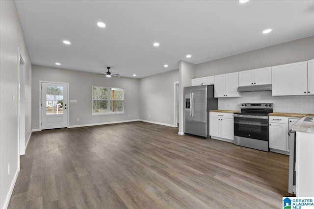 kitchen featuring appliances with stainless steel finishes, tasteful backsplash, ceiling fan, hardwood / wood-style floors, and white cabinetry