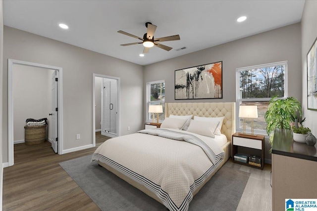 bedroom with hardwood / wood-style floors, ensuite bath, and ceiling fan