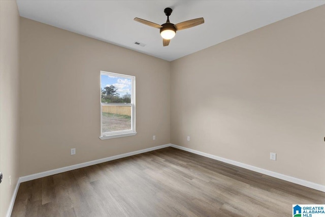 spare room featuring ceiling fan and light hardwood / wood-style flooring