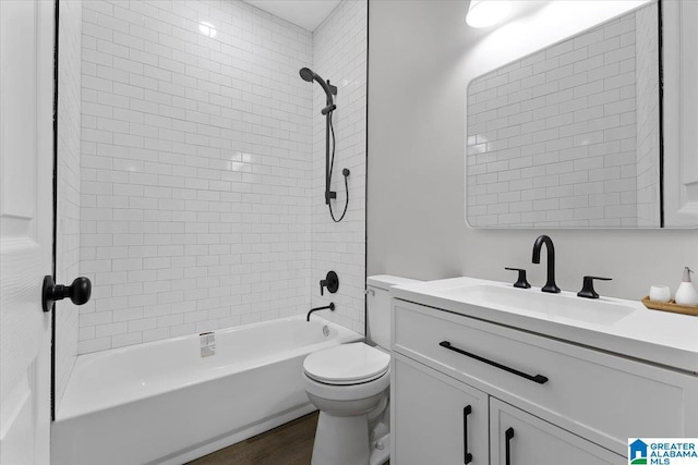 full bathroom with hardwood / wood-style floors, vanity, toilet, and tiled shower / bath