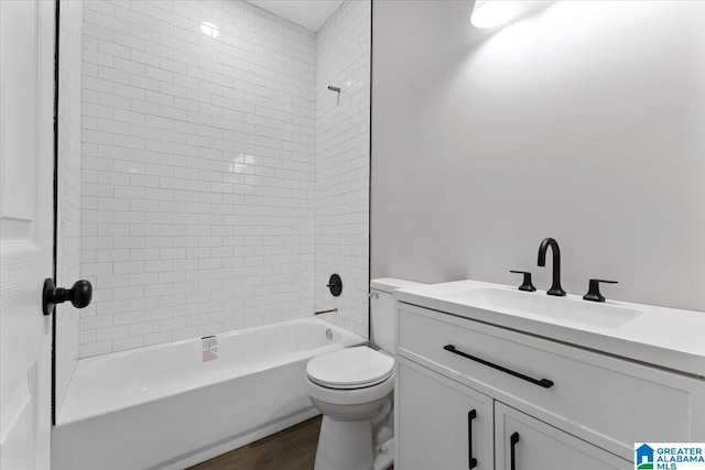 full bathroom featuring wood-type flooring, vanity, toilet, and tiled shower / bath