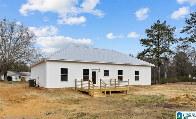 back of property featuring central AC unit and a wooden deck