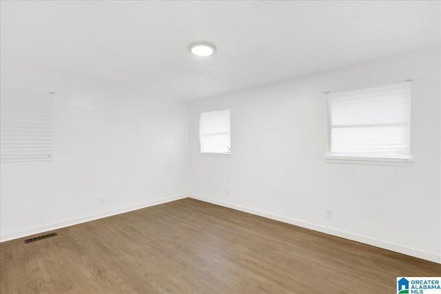 empty room with wood-type flooring