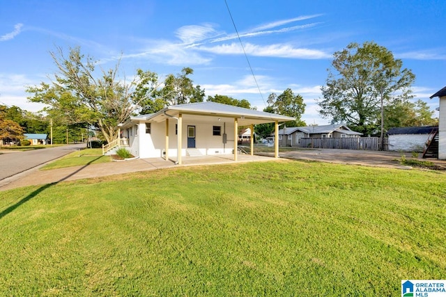 view of front of property featuring a water view, a front lawn, and a carport