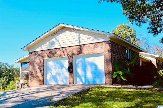 rear view of property featuring a garage