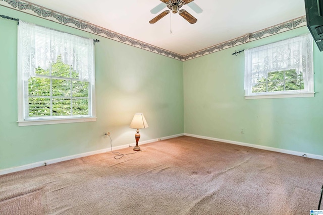 unfurnished room featuring ceiling fan, carpet flooring, and a healthy amount of sunlight