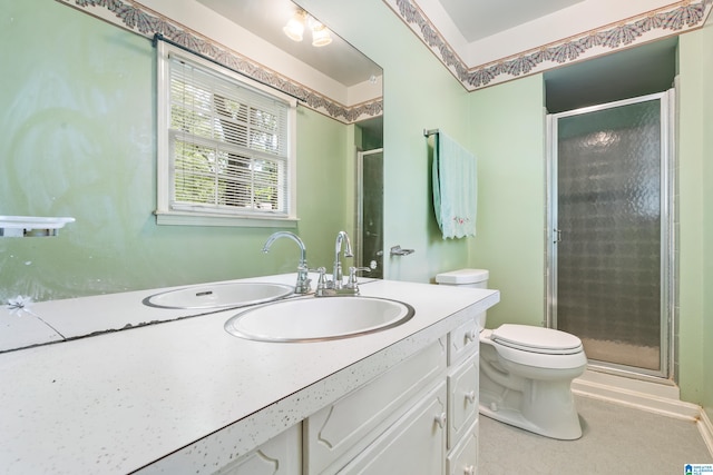 bathroom with vanity, toilet, and an enclosed shower