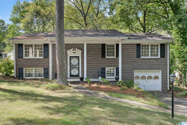 bi-level home with a front yard and a garage