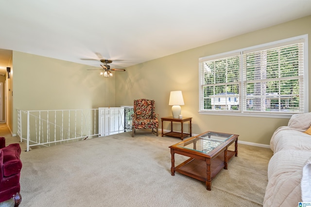 carpeted living room with ceiling fan