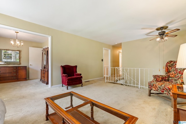 living area with carpet floors and ceiling fan with notable chandelier