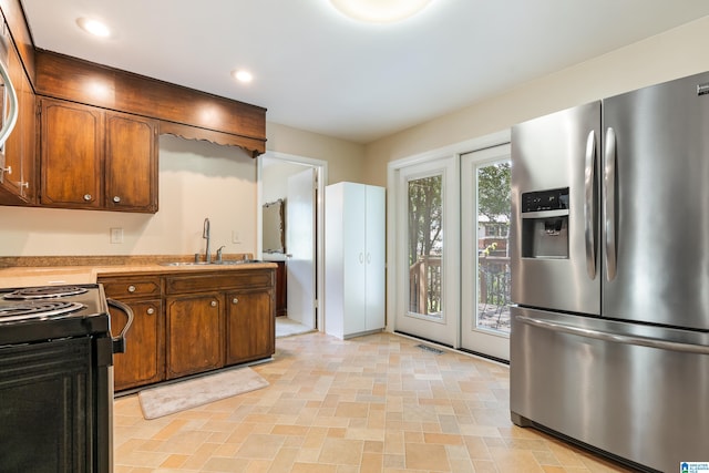 kitchen with black range with electric cooktop, sink, and stainless steel fridge with ice dispenser